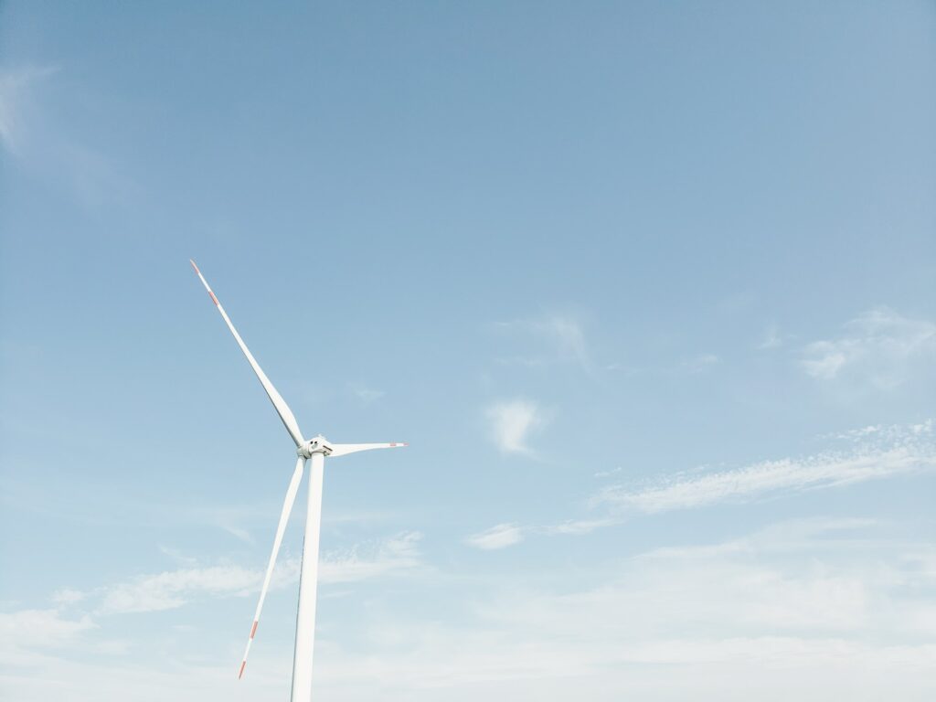 wind mill under blue sky and white clouds during daytime